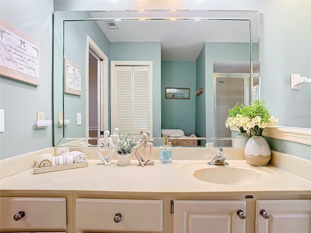 bathroom featuring vanity and a shower with shower door