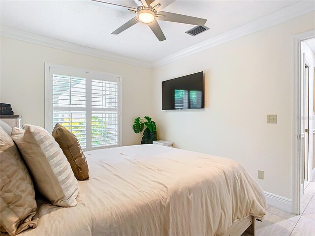 tiled bedroom featuring crown molding and ceiling fan