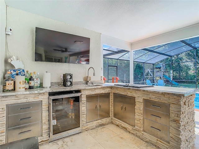 exterior space with stainless steel gas cooktop, wine cooler, light tile patterned flooring, and sink