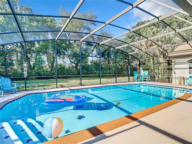 view of swimming pool featuring a patio and a lanai