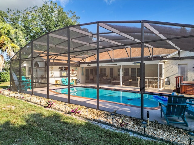 view of swimming pool with a patio and a lanai