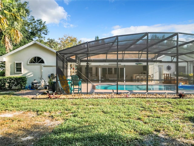 back of property featuring a yard, a patio area, and a lanai