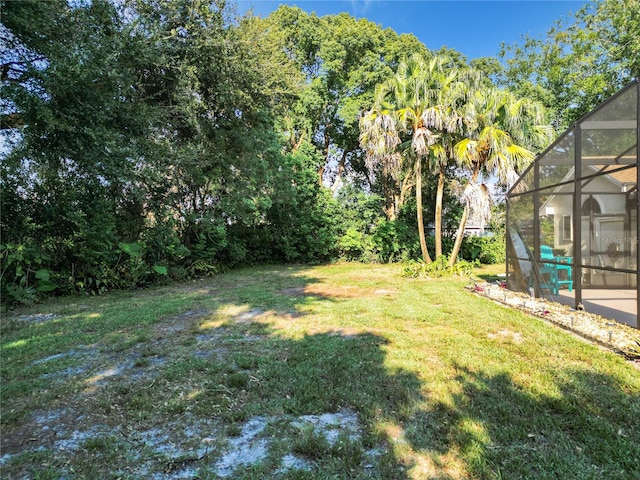 view of yard featuring glass enclosure