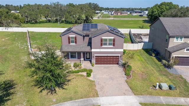 view of front of property with a garage and a front lawn