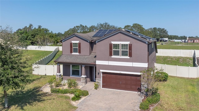 view of front facade featuring a front yard, a garage, and solar panels