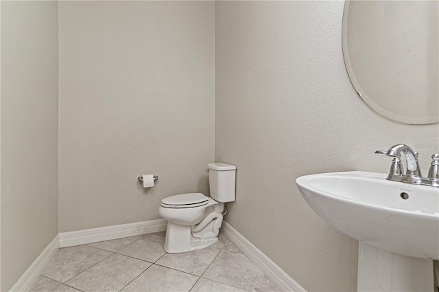 bathroom with tile patterned floors, sink, and toilet