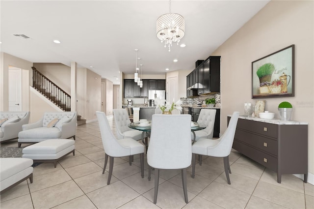 tiled dining space with a notable chandelier