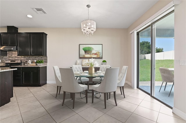 dining space with a chandelier and light tile patterned floors