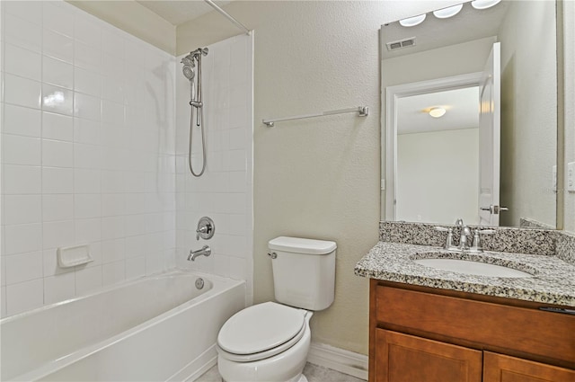 full bathroom featuring vanity, tiled shower / bath combo, and toilet