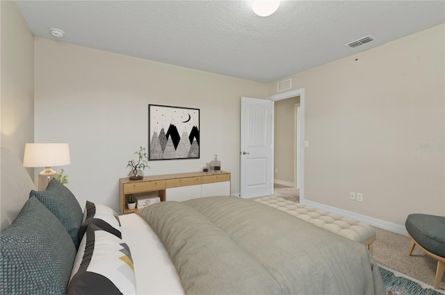 carpeted bedroom with a textured ceiling