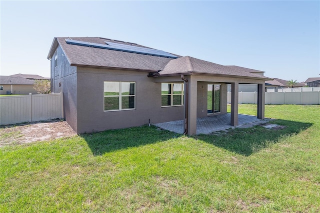 rear view of property featuring a yard and a patio