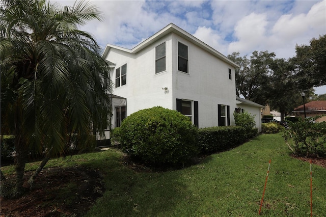 view of side of property with a yard