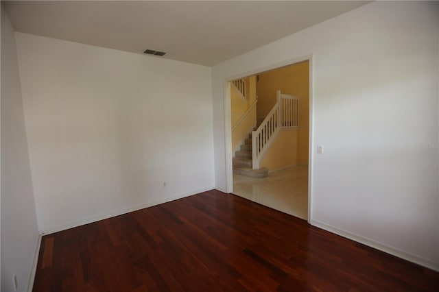 empty room featuring dark hardwood / wood-style flooring