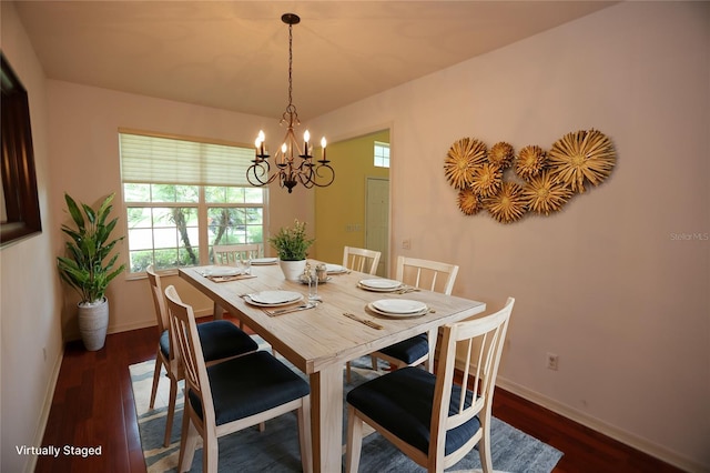 dining room featuring dark hardwood / wood-style floors and a chandelier