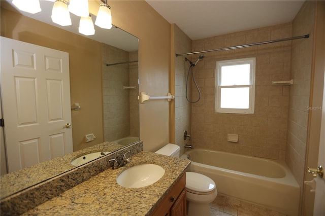 full bathroom with toilet, tiled shower / bath, vanity, and tile patterned floors