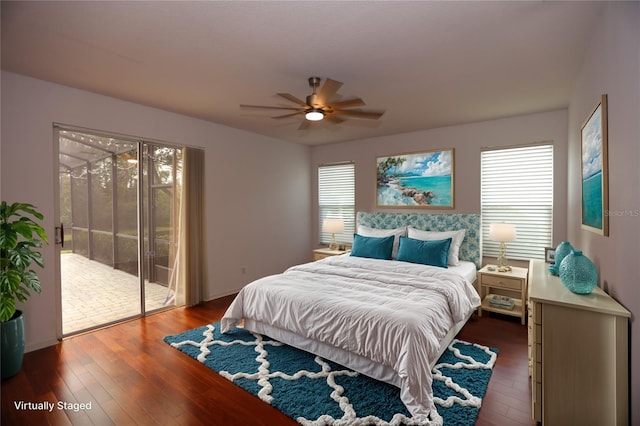 bedroom featuring multiple windows, dark hardwood / wood-style floors, access to exterior, and ceiling fan