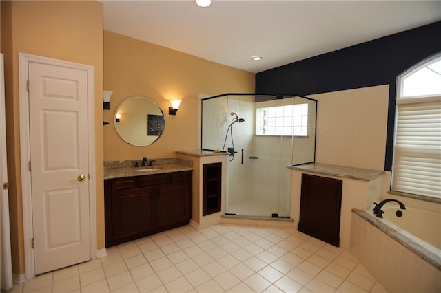 bathroom featuring vanity, independent shower and bath, and tile patterned floors