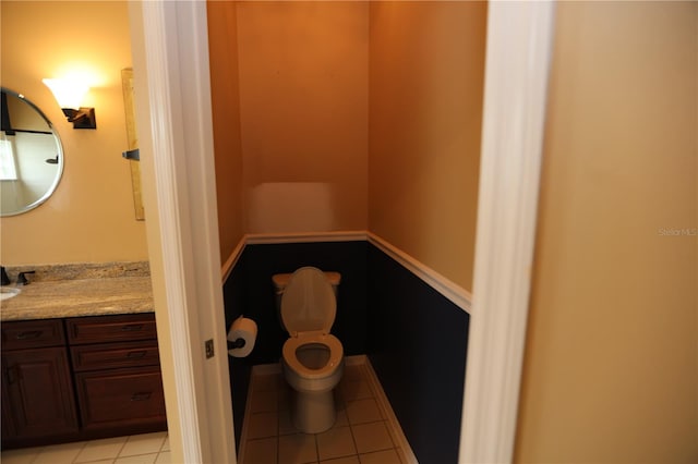 bathroom with vanity, toilet, and tile patterned flooring