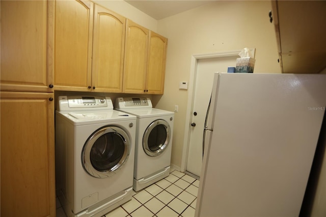 laundry room with light tile patterned flooring, cabinets, and separate washer and dryer