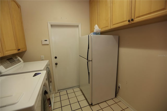 laundry area featuring washing machine and clothes dryer and light tile patterned floors