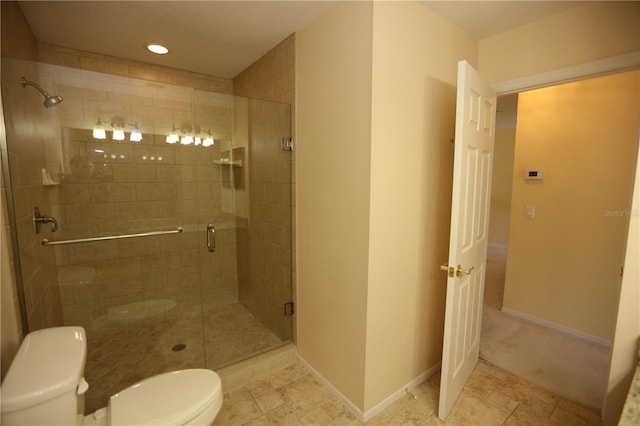 bathroom with toilet and an enclosed shower