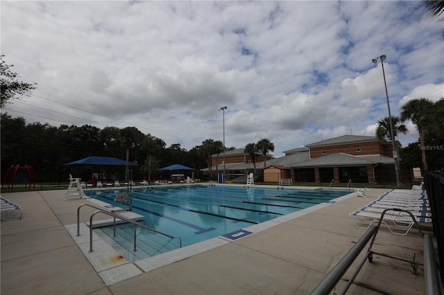 view of swimming pool featuring a patio area