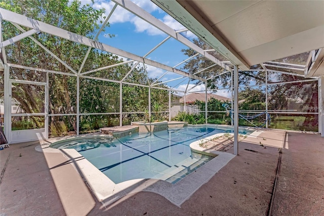 view of pool with a patio area, a hot tub, and a lanai