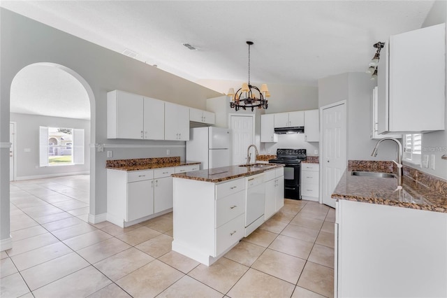 kitchen with an island with sink, white appliances, sink, and white cabinets