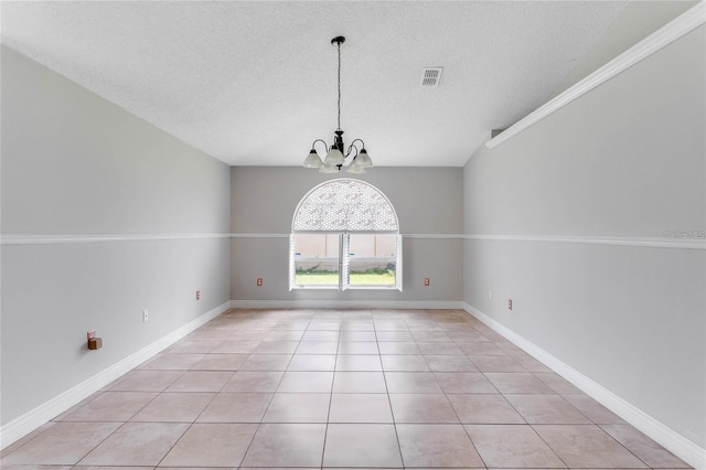 unfurnished dining area featuring light tile patterned flooring, an inviting chandelier, and a textured ceiling