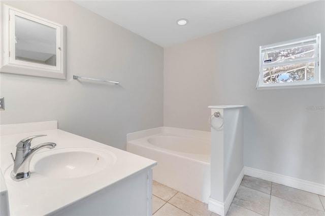 bathroom with tile patterned floors, vanity, and a bath