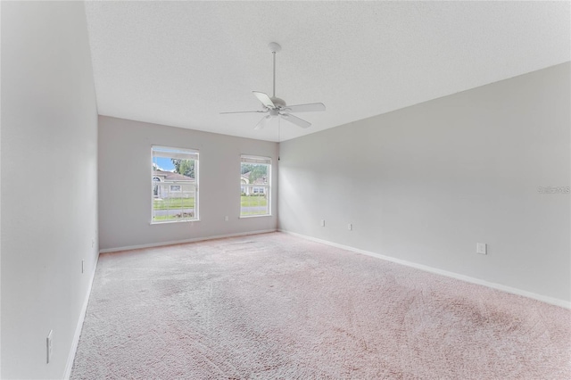 carpeted empty room featuring a textured ceiling and ceiling fan