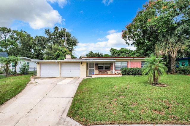 single story home featuring a front lawn and a garage