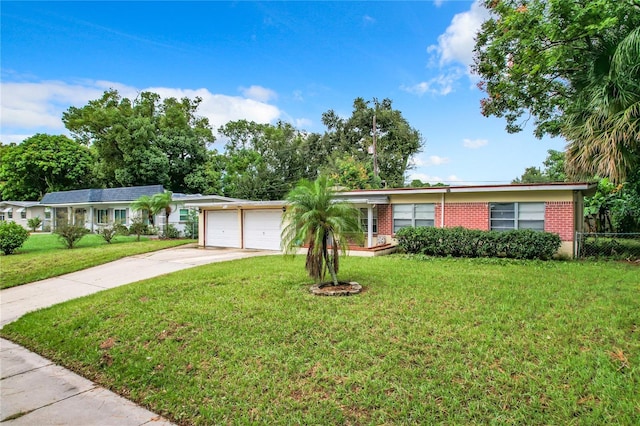 single story home featuring a garage and a front lawn