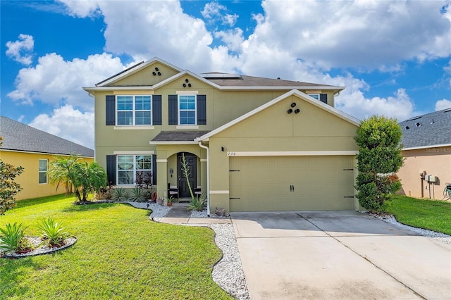 view of front of home with a front yard and a garage