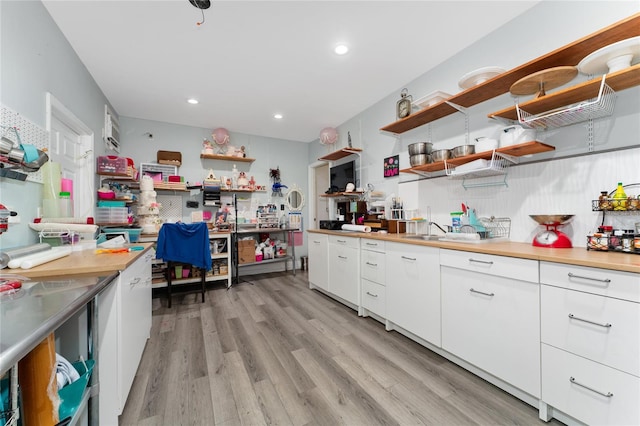 kitchen featuring white cabinets and light hardwood / wood-style flooring