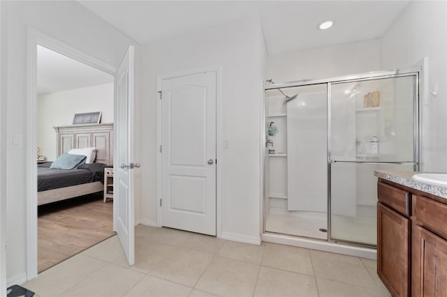 bathroom with walk in shower, vanity, and wood-type flooring