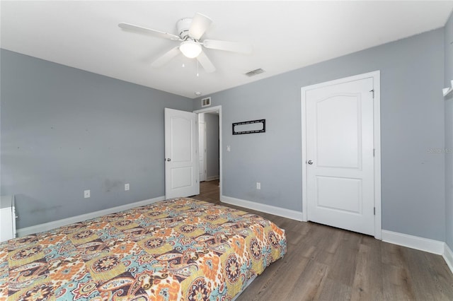 bedroom with ceiling fan and dark hardwood / wood-style flooring