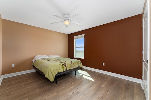 bedroom featuring ceiling fan and wood-type flooring