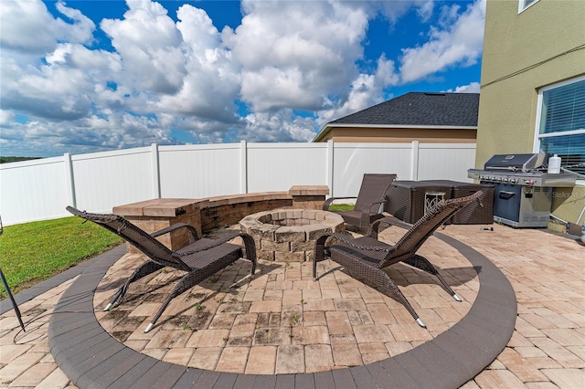 view of patio featuring area for grilling and a fire pit