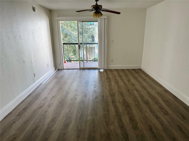 unfurnished room with dark wood-type flooring, a textured ceiling, and ceiling fan