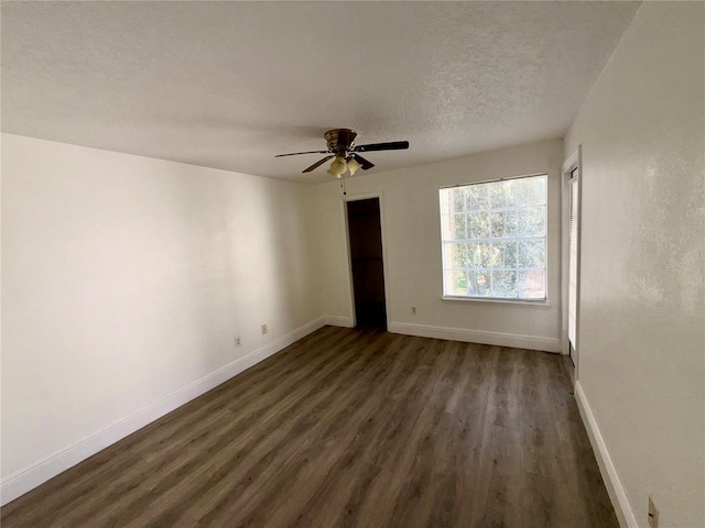 unfurnished room with ceiling fan, a textured ceiling, and dark hardwood / wood-style flooring