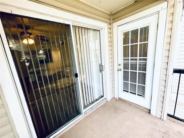 view of exterior entry with a patio