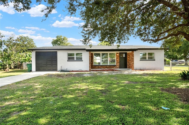 ranch-style house featuring a front yard and a garage