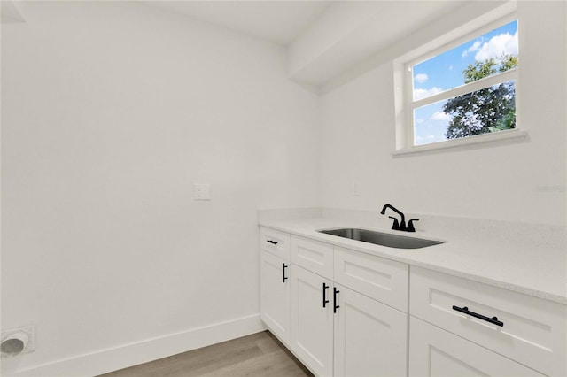 interior space featuring light hardwood / wood-style flooring, cabinets, and sink