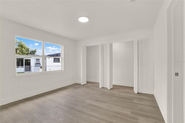 unfurnished bedroom featuring light wood-type flooring