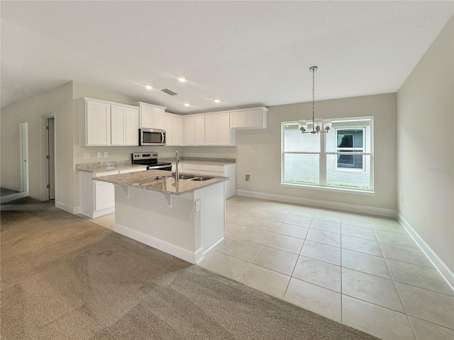 kitchen with light carpet, sink, light stone counters, white cabinets, and appliances with stainless steel finishes