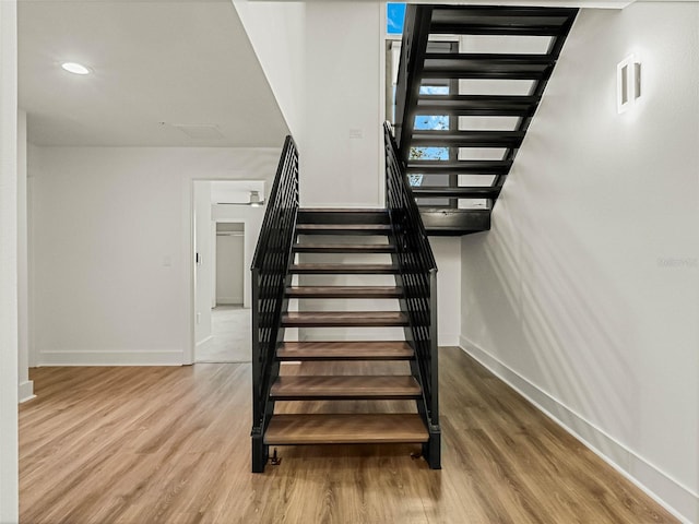 stairs with hardwood / wood-style floors