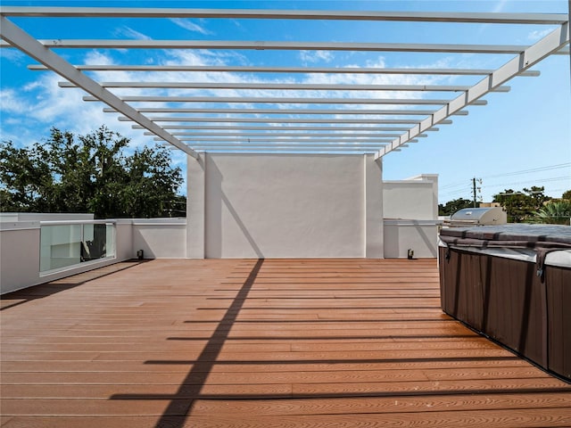 wooden terrace featuring a pergola, a hot tub, and grilling area