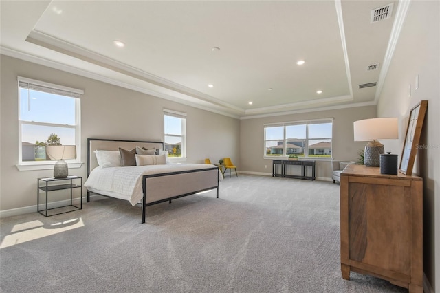 carpeted bedroom with multiple windows, ornamental molding, and a tray ceiling