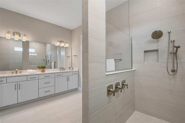 bathroom with vanity and tiled shower